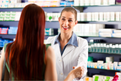Pharmacist giving medicine to costumer